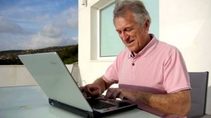 stock-footage-senior-man-surfing-on-internet-outside-the-house