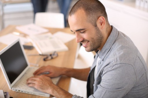 bigstock-Smiling-young-man-in-office-wo-53536654-720x480