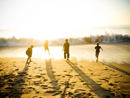 kids-running-into-water-on-beach