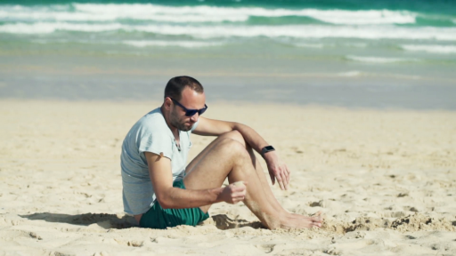 unhappy-sad-man-sitting-on-beach_nyjvhfxc__f0000